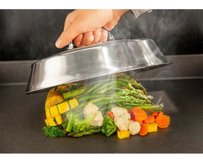 a Blackstone - 12inch Basting Cover used to cooked steamed veggies over a griddle