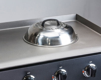 a Blackstone - 12inch Basting Cover placed over a griddle