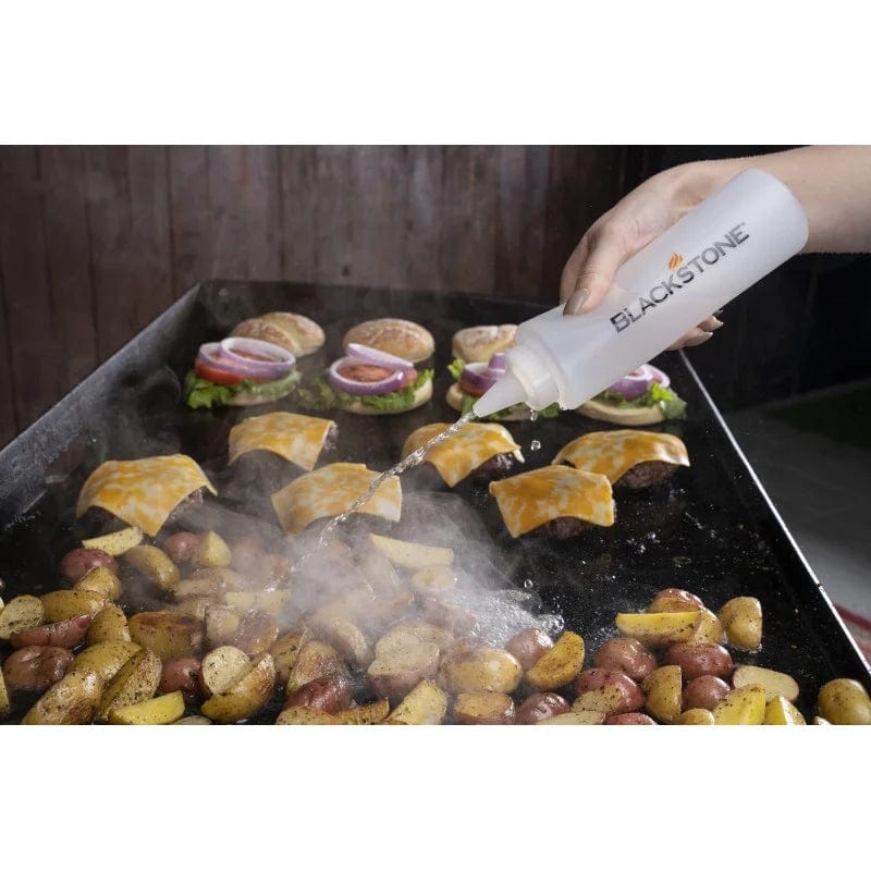 using Blackstone Griddle Professional Toolkit 5 Piece to spray food