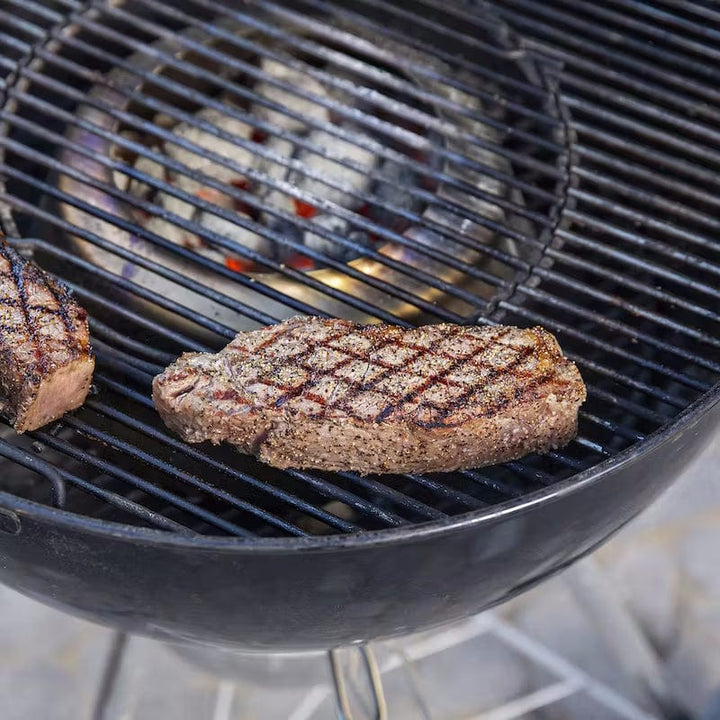 meat on a grill with Weber Charcoal Heat Controller