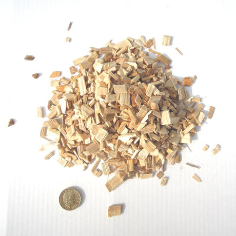 Close-up image of an ample amount of Hickory Wood Smoking Chips and a coin penny as its chip size comparison reference