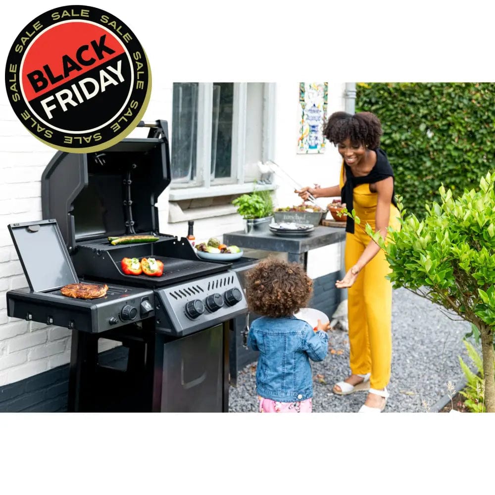 a woman and child grilling food on Napoleon Freestyle 365 SIB and smiling