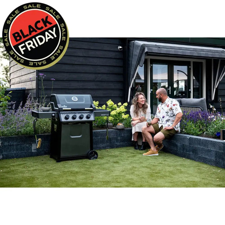 poeple hanging out outdoors next to Napoleon Freestyle 425 4-Burner Gas Grill