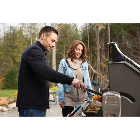 man and woman grilling on Napoleon Prestige PRO 665 RSIB