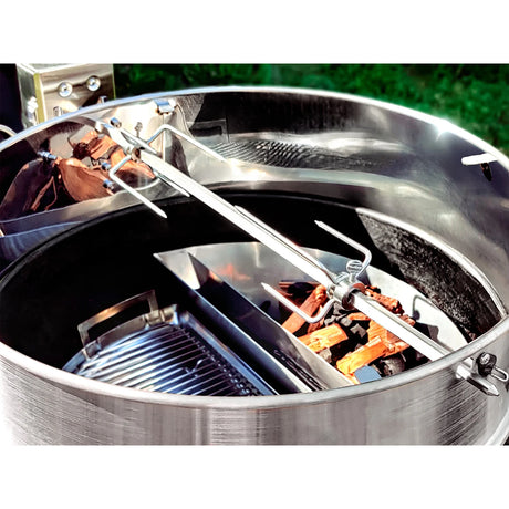 A closer look at a Slow 'N Sear® Kettle Ring Rotisserie Kit that is fitted on top a prepped kettle grill without the lid.