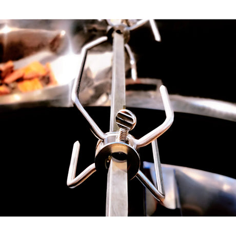 Close-up view of a Slow 'N Sear® Kettle Ring Rotisserie Kit's meat forks attached to a rotisserie skewer.