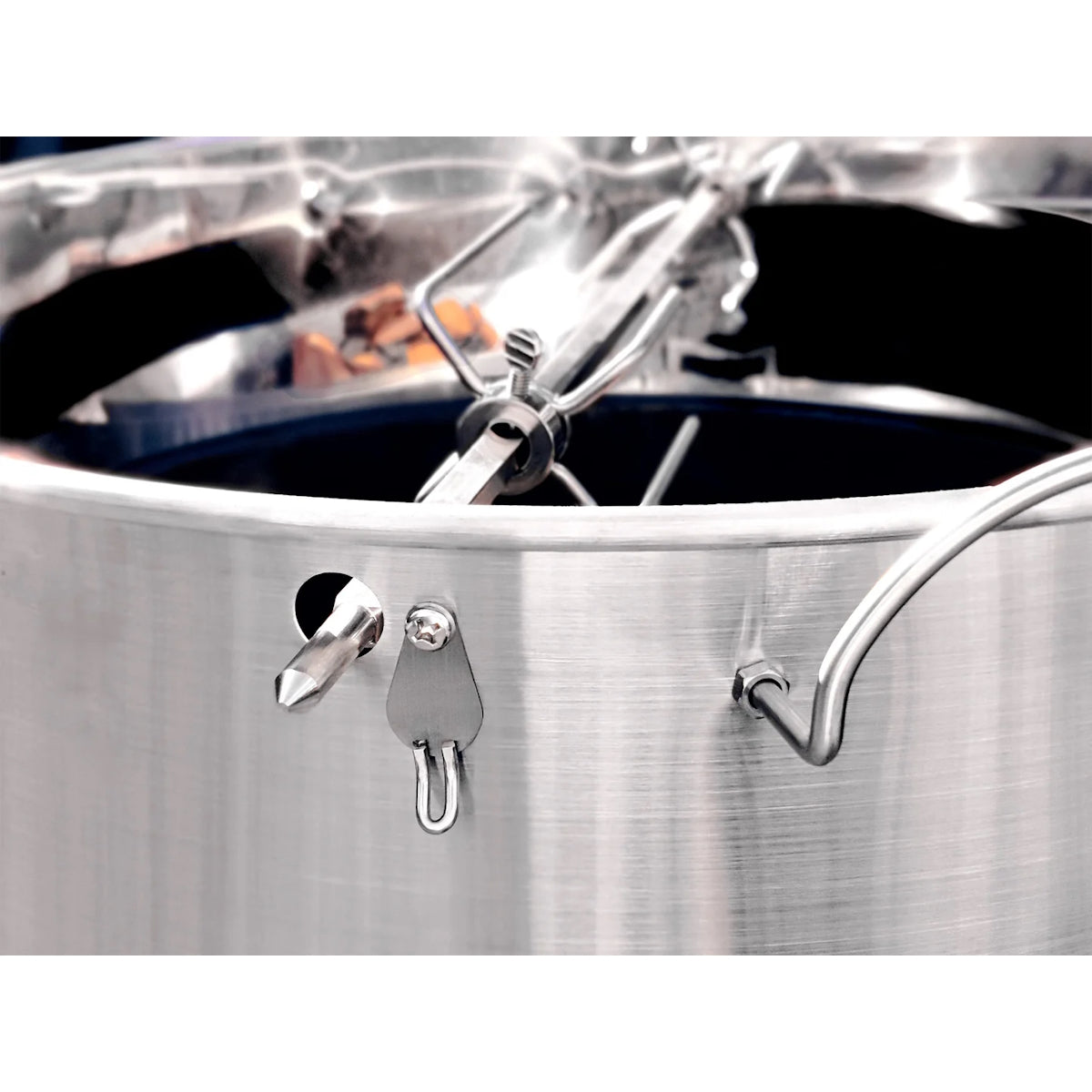 Close-up view of a Slow 'N Sear® Kettle Ring Rotisserie Kit placed on top of a smoking kettle grill.