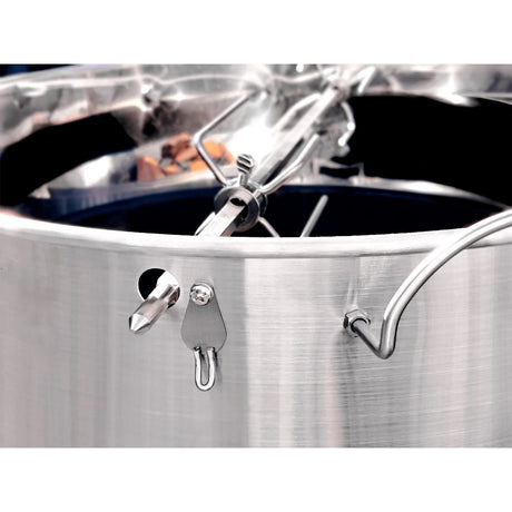 Close-up view of a Slow 'N Sear® Kettle Ring Rotisserie Kit placed on top of a smoking kettle grill.