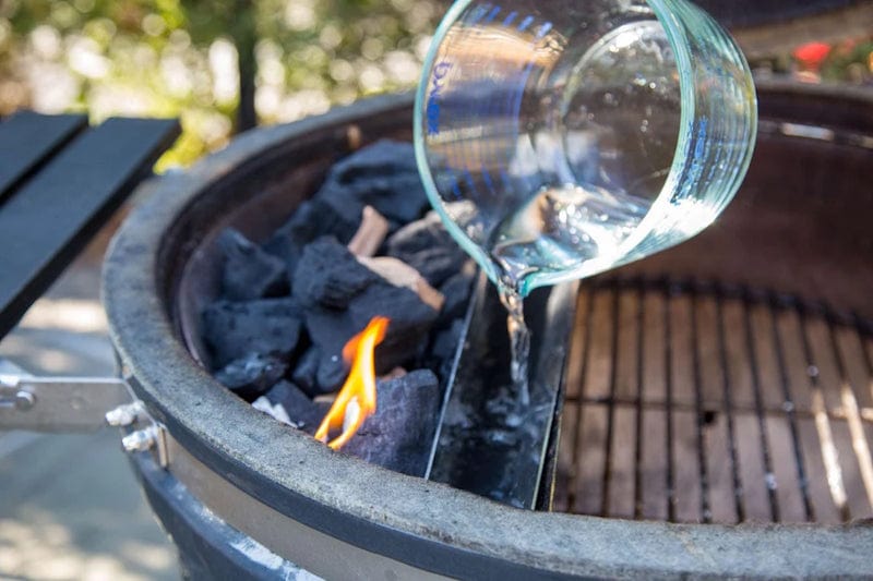 pouring water into Slow ‘N Sear  Deluxe Insert