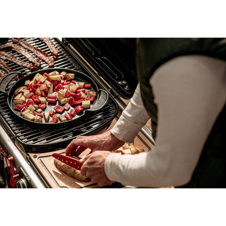 preparing meal on a Weber Traveler Gas Barbecue