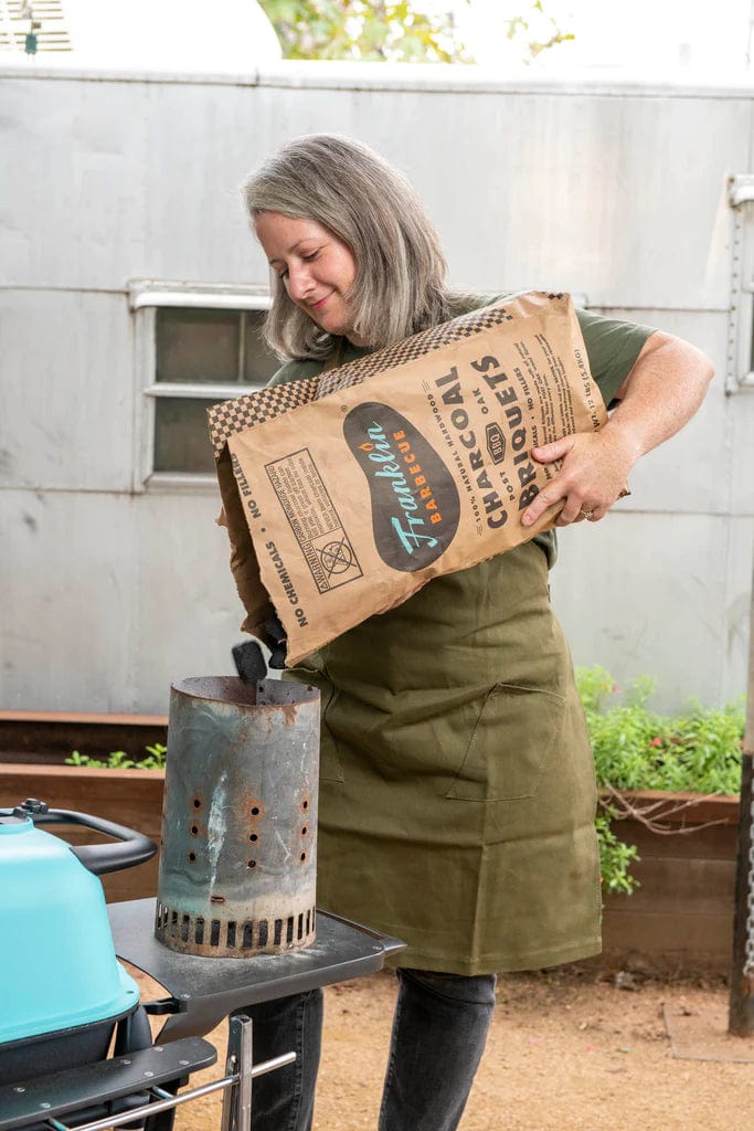 filling firebox with Franklin Barbecue Charcoal Briquette