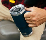 a man's hand holding a blue YETI - Rambler Travel Mug
