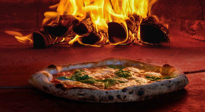 pizza and logs in a grill